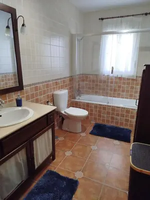 a bathroom with a toilet and a sink and a tub at Chalet Jones in Chiclana de la Frontera