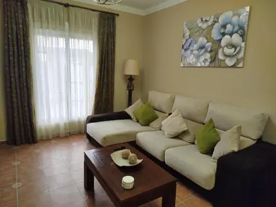 a living room with a couch and a coffee table at Chalet Jones in Chiclana de la Frontera