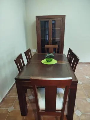 a dining room table and chairs with a pineapple on top at Chalet Jones in Chiclana de la Frontera