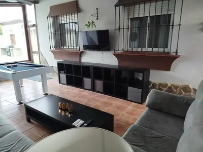 a living room with a couch and a table at Chalet Jones in Chiclana de la Frontera