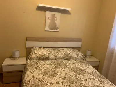 a bedroom with a bed and two night stands at Casa Jones in Chiclana de la Frontera