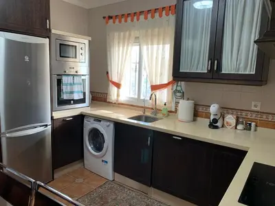 a kitchen with a washer and a sink and a dishwasher at Casa Jones in Chiclana de la Frontera