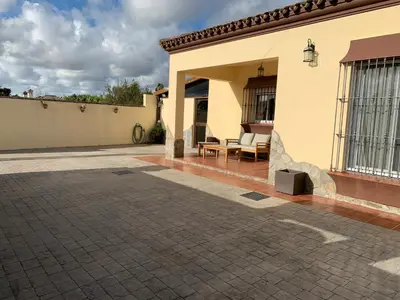 a patio of a house with a table and chairs at Casa Jones in Chiclana de la Frontera