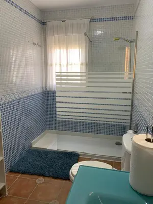 a bathroom with a tub and a toilet and a sink at Casa Jones in Chiclana de la Frontera