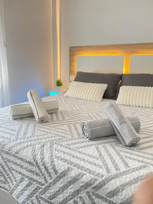 a large bed with two pillows on top of it at Apartamento Las Sirenas in Chipiona