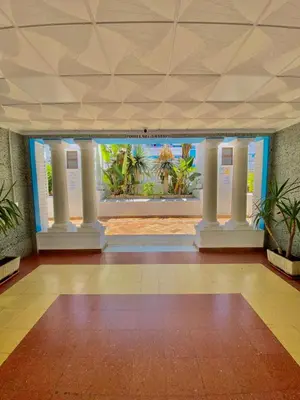 a room with columns and a wall with plants at Apartamento Las Sirenas in Chipiona