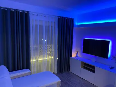 a living room with a tv and blue lights at Apartamento Las Sirenas in Chipiona