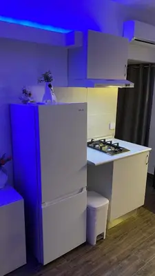 a kitchen with a white refrigerator and a stove at Apartamento Las Sirenas in Chipiona