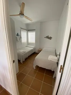 a room with two beds and a window at Costa ballena en primera linea in Costa Ballena