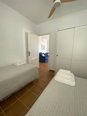 a bedroom with two beds and a ceiling fan at Costa ballena en primera linea in Costa Ballena