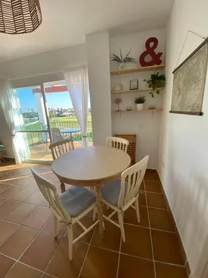 a dining room with a table and chairs at Costa ballena en primera linea in Costa Ballena