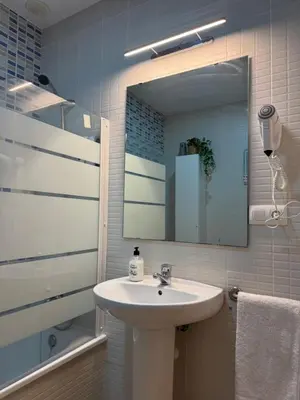 a bathroom with a sink and a mirror at BARROSA CON ENCANTO, AC - WIFI - PARKING, Parejas y familias in Novo Sancti Petri