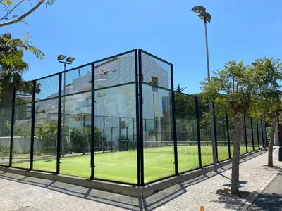 a glass building with a tennis court inside at BARROSA CON ENCANTO, AC - WIFI - PARKING, Parejas y familias in Novo Sancti Petri