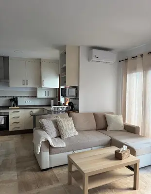 a living room with a couch and a coffee table at BARROSA CON ENCANTO, AC - WIFI - PARKING, Parejas y familias in Novo Sancti Petri