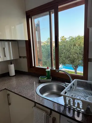 a kitchen counter with a sink and a window at BARROSA CON ENCANTO, AC - WIFI - PARKING, Parejas y familias in Novo Sancti Petri