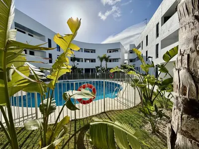 a pool in front of a building with plants at El rincon de candor by staycare in Rota
