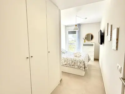 a small bedroom with a bed and a window at El rincon de candor by staycare in Rota