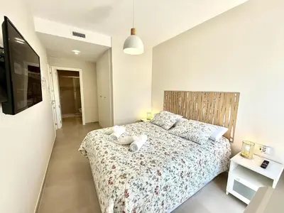 a bedroom with a bed with two stuffed animals on it at El rincon de candor by staycare in Rota
