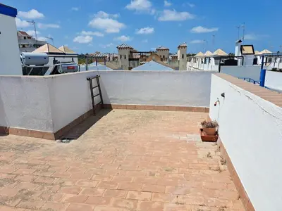 a patio on top of a building with a wall at El Patio Grande in Sanlúcar de Barrameda