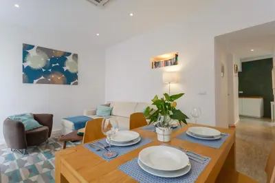 a living room with a table with plates and wine glasses at ALBA Apartment by Cadiz4Rentals in Cádiz
