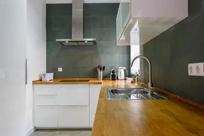 a kitchen with white cabinets and a sink at ALBA Apartment by Cadiz4Rentals in Cádiz