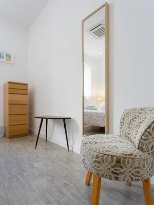 a room with a chair and a mirror at ALBA Apartment by Cadiz4Rentals in Cádiz