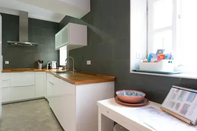 a kitchen with white cabinets and a sink and a window at ALBA Apartment by Cadiz4Rentals in Cádiz