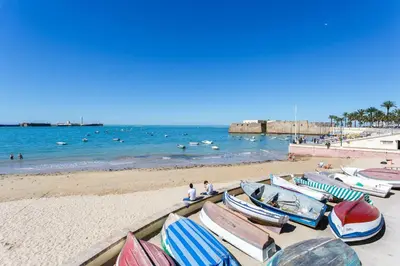a group of boats sitting on the beach at ALBA Apartment by Cadiz4Rentals in Cádiz