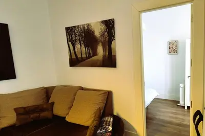 a living room with a couch and a painting on the wall at Tacita de Plata by Gades Gestion in Cádiz