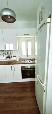 a kitchen with white cabinets and a white refrigerator at Tacita de Plata by Gades Gestion in Cádiz