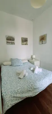 a bedroom with a large bed with pillows on it at Tacita de Plata by Gades Gestion in Cádiz