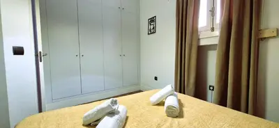a bedroom with a bed with towels on it at Tacita de Plata by Gades Gestion in Cádiz