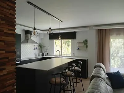 a kitchen with a large island with bar stools at Amplio Apartamento ARCOS in Arcos de la Frontera