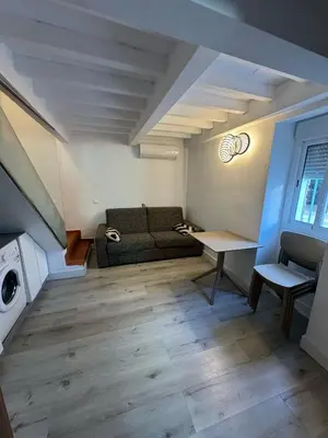 a living room with a couch and a table at Apto Nº1 LAVANDA y Apto Nº 3 JAZMIN in Chipiona