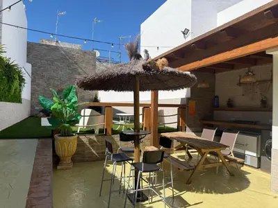 a small living room with a couch and a chair at Apto Nº1 LAVANDA y Apto Nº 3 JAZMIN in Chipiona