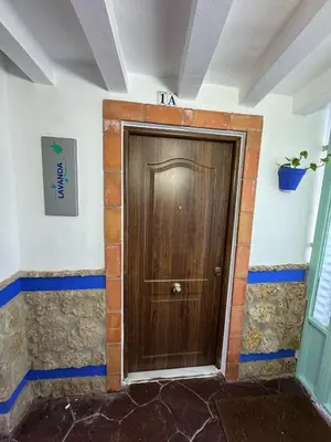 a wooden door in the corner of a room at Apto Nº1 LAVANDA y Apto Nº 3 JAZMIN in Chipiona