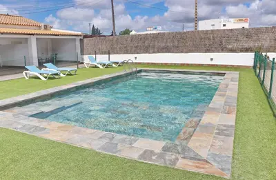 a swimming pool in the yard of a house at Apartamento Canario II in Conil de la Frontera
