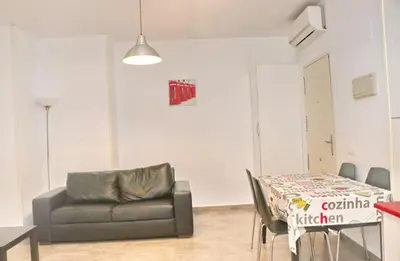 a living room with a couch and a table at Apartamento Canario II in Conil de la Frontera