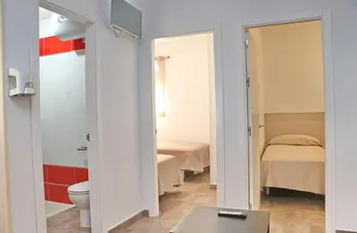 a bathroom with a bed and a toilet in a room at Apartamento Canario II in Conil de la Frontera