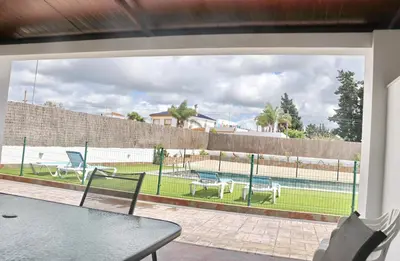 a patio with a view of a tennis court at Apartamento Canario II in Conil de la Frontera