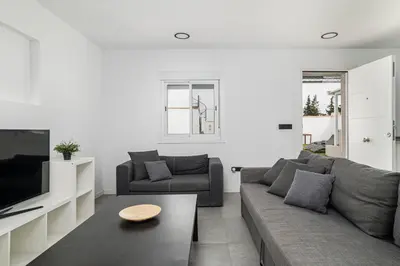 a living room with a couch and a tv at Chiclana Dreamhouse in Chiclana de la Frontera