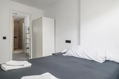 a bedroom with a large bed with towels on it at Chiclana Dreamhouse in Chiclana de la Frontera