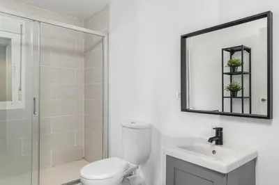 a bathroom with a toilet and a sink and a mirror at Chiclana Dreamhouse in Chiclana de la Frontera