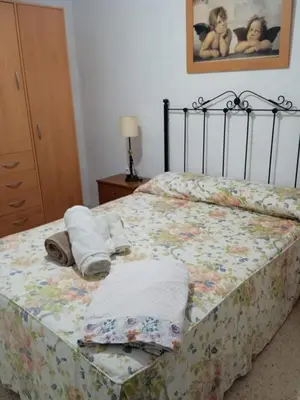 a bedroom with a bed with towels on it at La fuente in Novo Sancti Petri