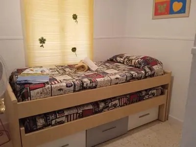 a bedroom with a bed with a wooden frame at La fuente in Novo Sancti Petri