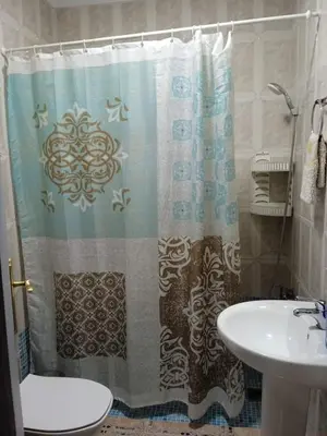 a bathroom with a shower curtain and a sink at La fuente in Novo Sancti Petri