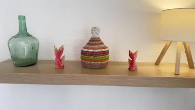 a shelf with three vases and a bottle on it at Frente al Mar in Novo Sancti Petri