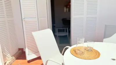 a white table with two glasses on top of it at Frente al Mar in Novo Sancti Petri