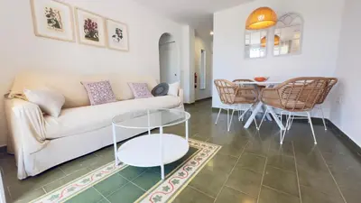 a living room with a couch and a table at Frente al Mar in Novo Sancti Petri