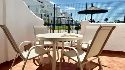 a white table and chairs on a balcony at Frente al Mar in Novo Sancti Petri